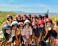 a bachelorette party group poses for a scenic picture on a phoenix arizona atv tour