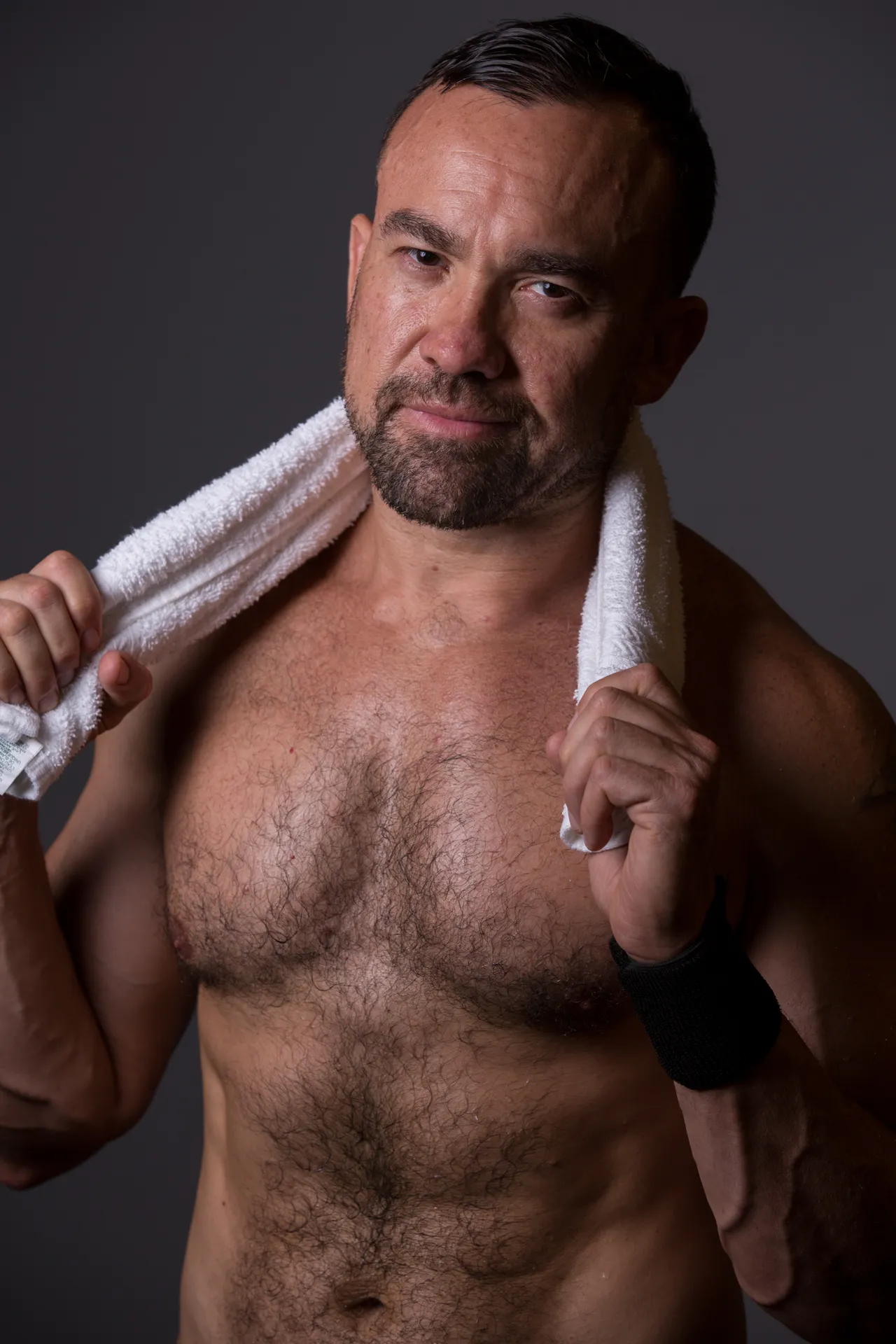 man with towel around neck posing for camera