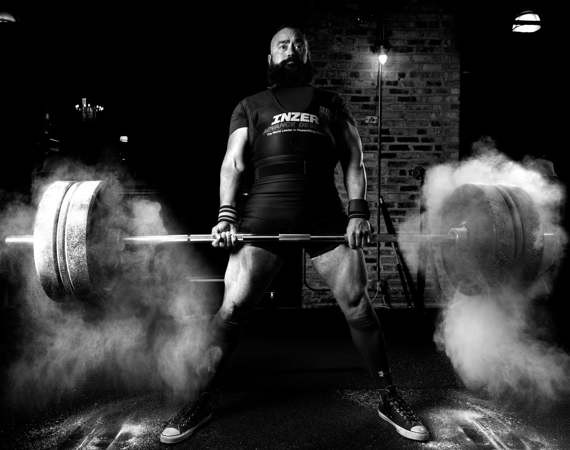 body builder lifting weights with flour falling off