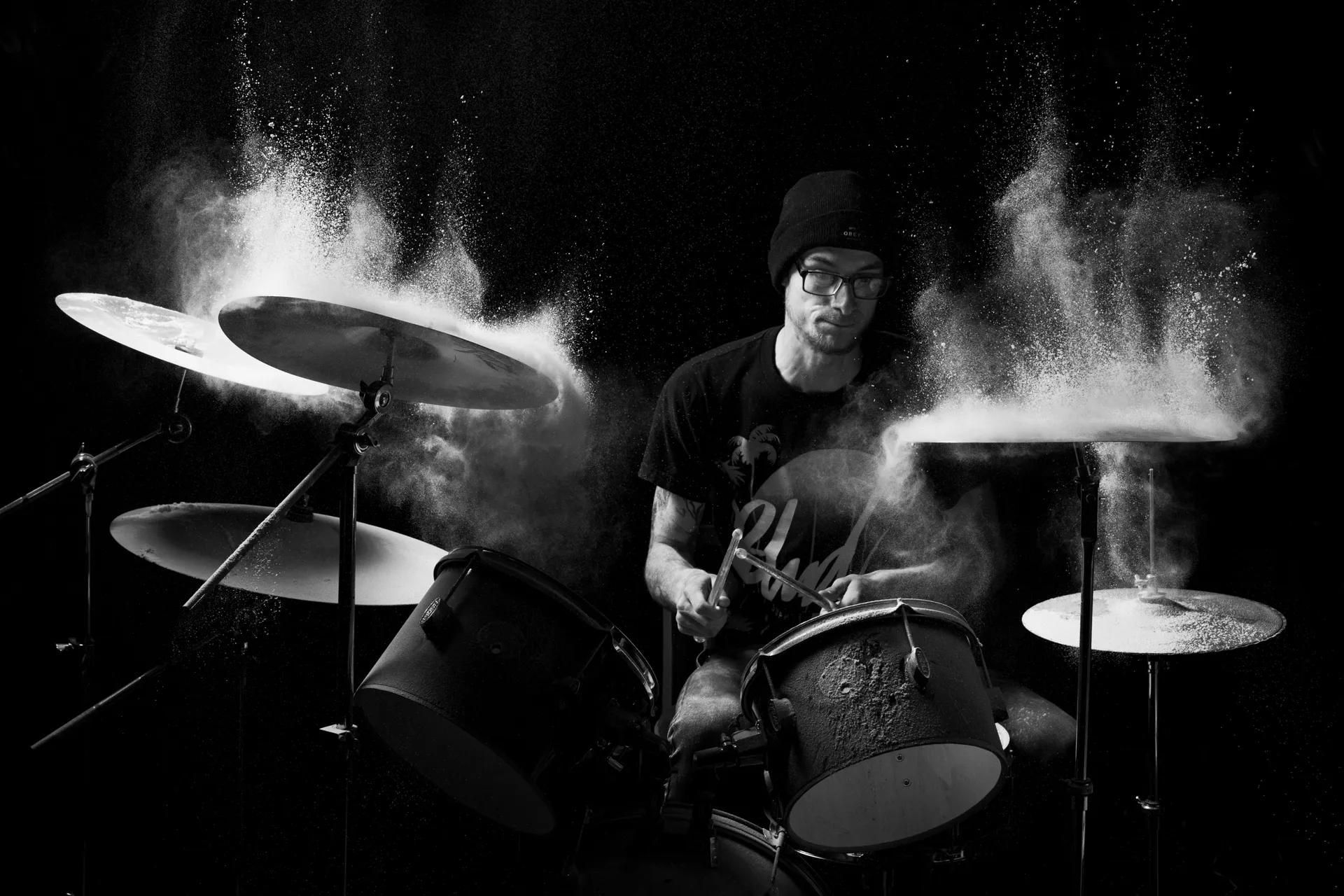 drummer playing with flour flying off cymbals