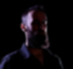 image of man with strong chiaroscuro (light - dark) lighting
