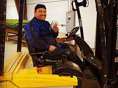 Happy forklift employee enjoying a snack from vending machine