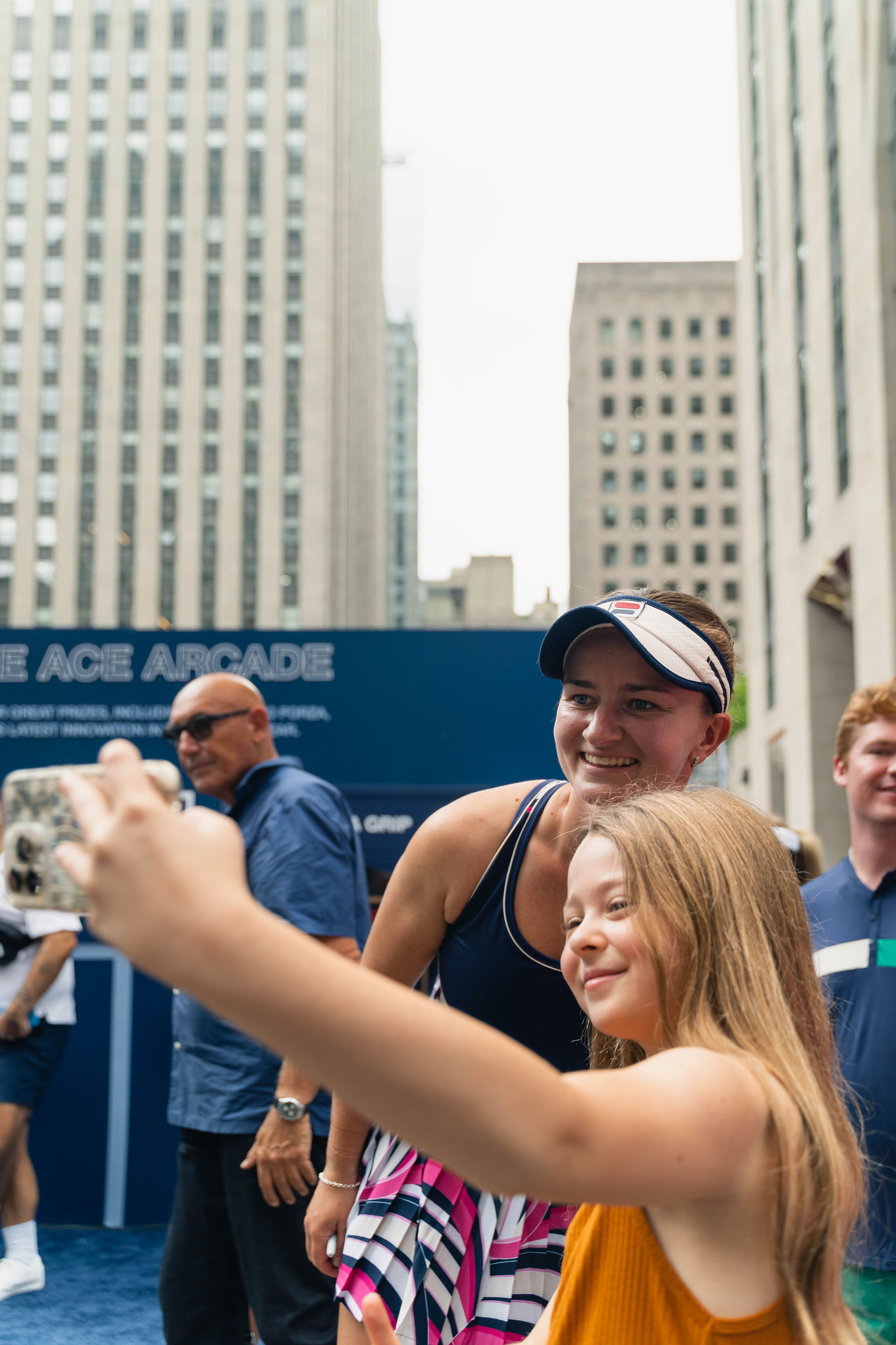 Young girl taking photo with tennis pro at Fila event