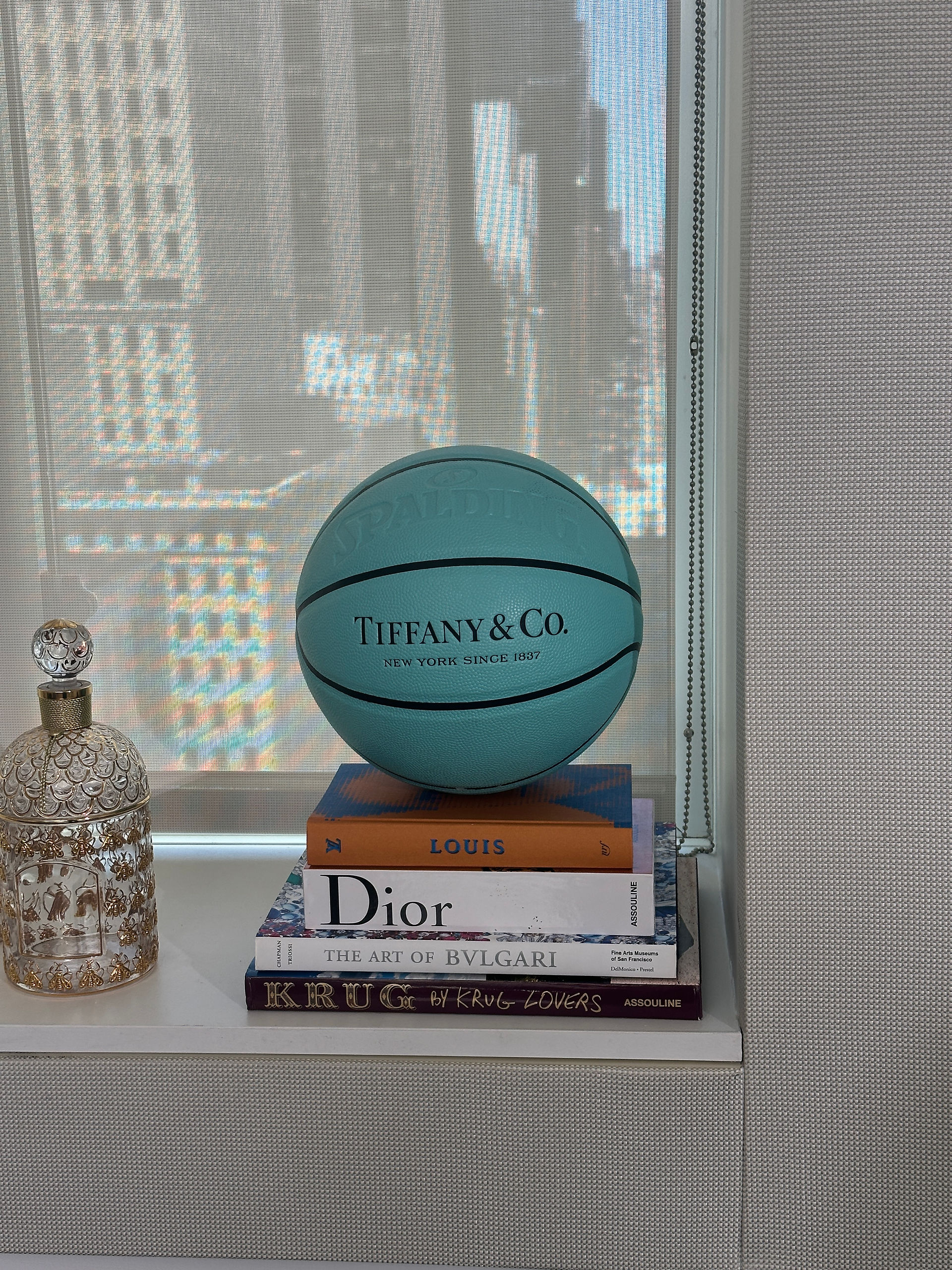 Tiffany & Co basketball on stack of books
