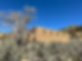 Sego Ghost Town, Old stone building in a desert landscape, surrounded by dry brush and a leafless cottonwood tree under a clear blue sky, bring back memories of past times in the old americain southwest.