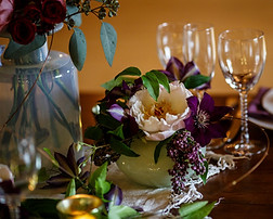Boho Chic centerpiece eggplant purple and cream in a hand blown vessel by Mambo fiori best wedding florist Temecula CA