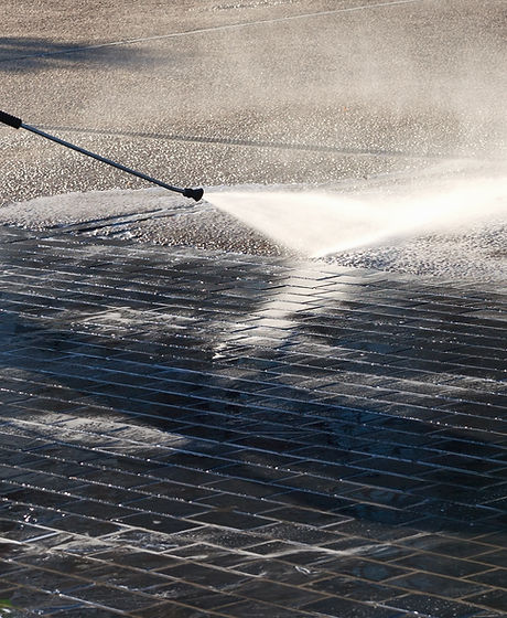 Wet cleaning of street with pressurized