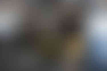 Glass meeting room with lounge seating in Applied Innovation office