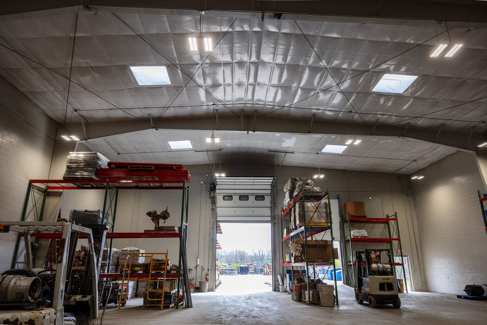 Restored warehouse space with upgraded lighting and overhead door systems