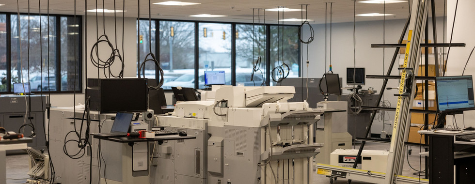 Print production area with natural light and equipment at Applied Innovation Grand Rapids