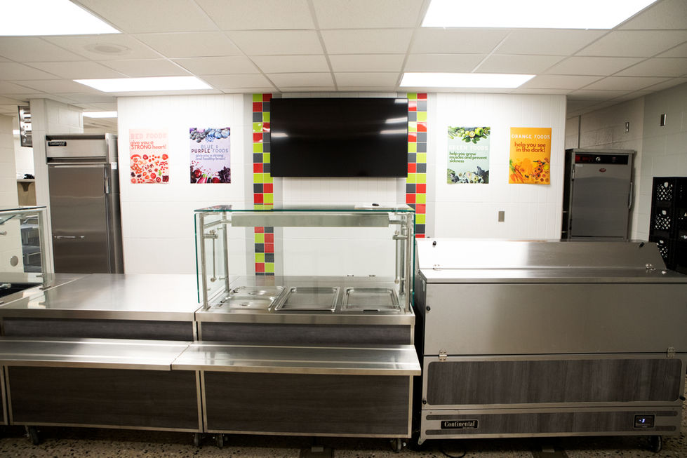 School serving line with stainless steel counters and food service equipment