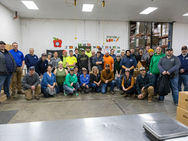 Group photo of volunteers after food drive event at Feeding America West Michigan