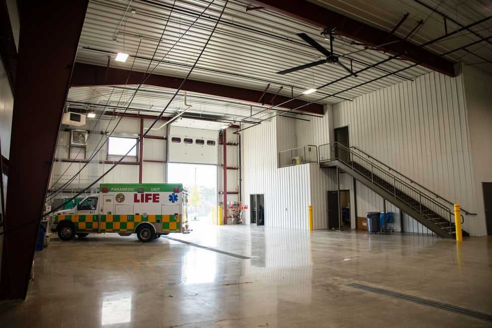 Ambulance parked inside a spacious, modern garage.
