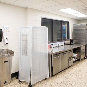 School commercial kitchen with stainless steel appliances and food service equipment