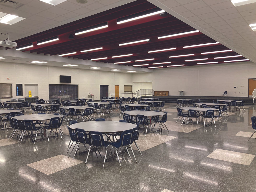 Empty cafeteria with round tables and chairs.