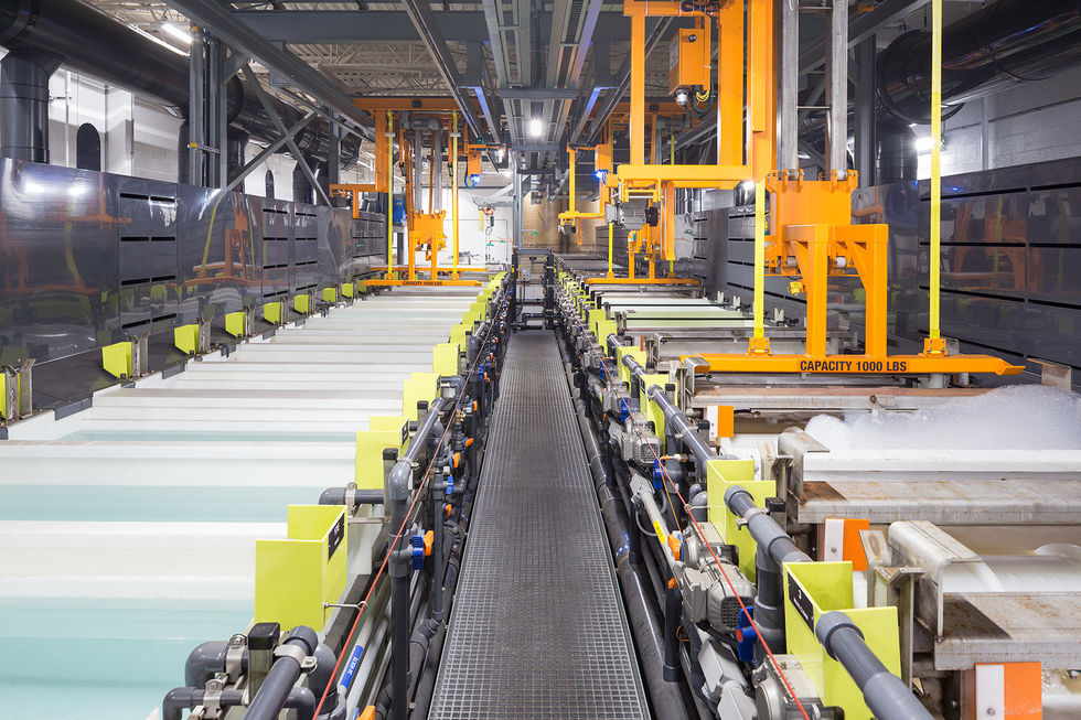 Industrial processing line with tanks and piping for metal finishing operations