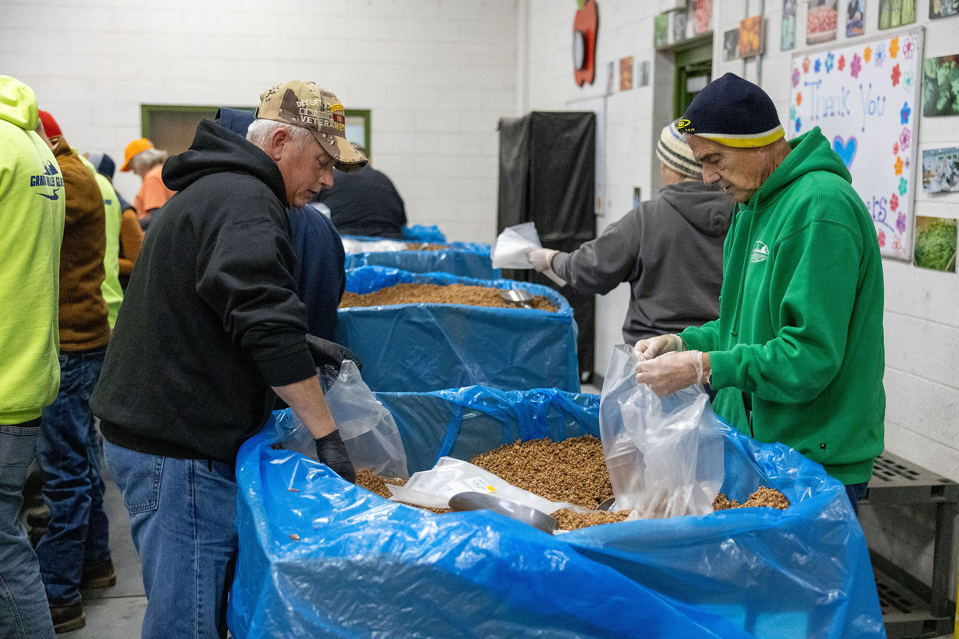Team assembling and sealing food packages for distribution to families in need