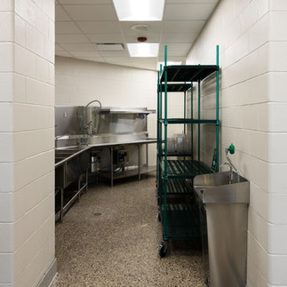 Kitchen prep area with storage racks in Kentwood Public Schools renovation
