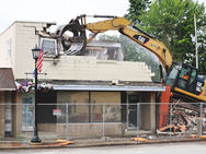 Construction crew demolishing downtown Sparta building to prepare for new development