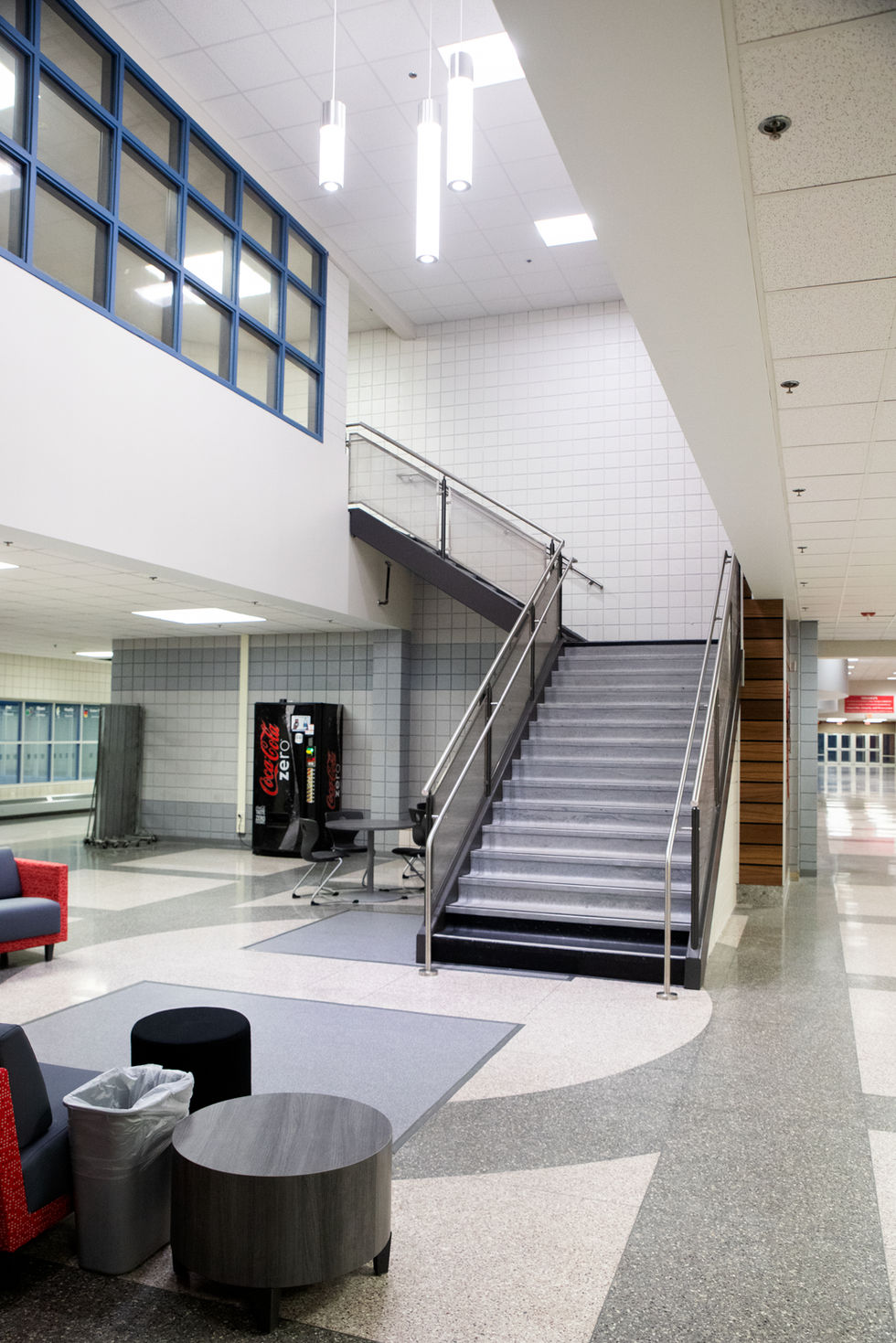 Modern interior with staircase and seating area.