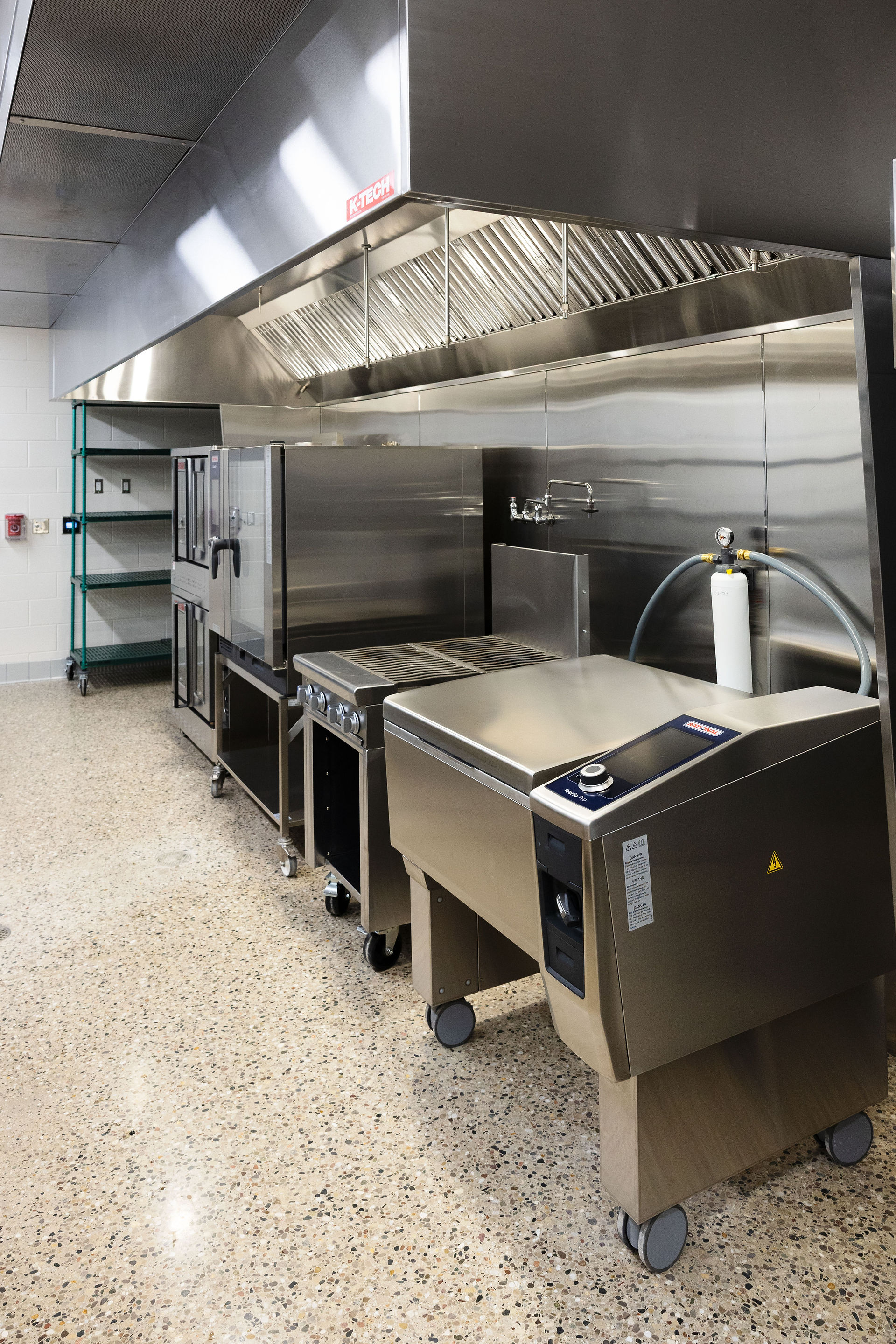 Stainless steel prep station and sink area in new school kitchen renovation