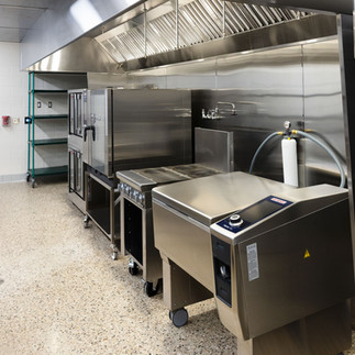 Stainless steel prep station and sink area in new school kitchen renovation