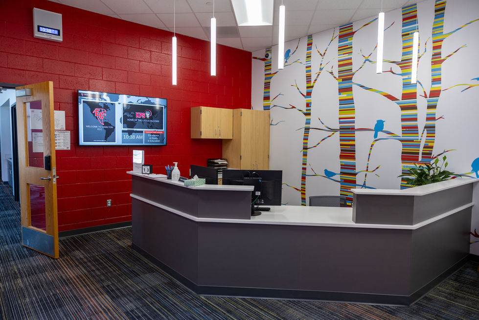 School reception area with secure entry desk and modern interior finishes