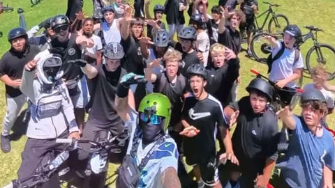 Bikelife with Chuuur rideout crew riding away down a Melbourne west street, shot from ground level with motion blur, no faces visible