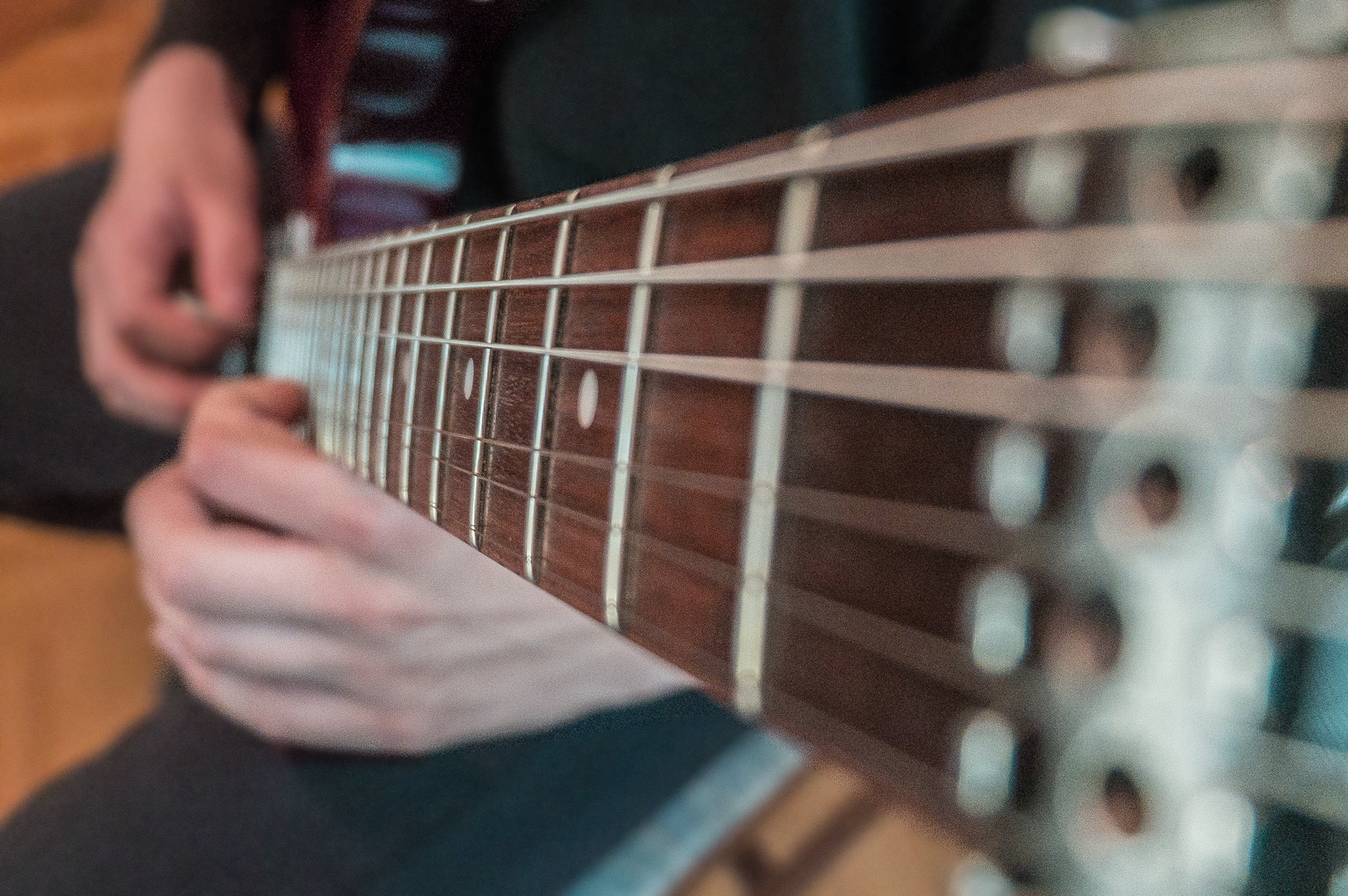 Guitar neck of a guitar player that's practicing
