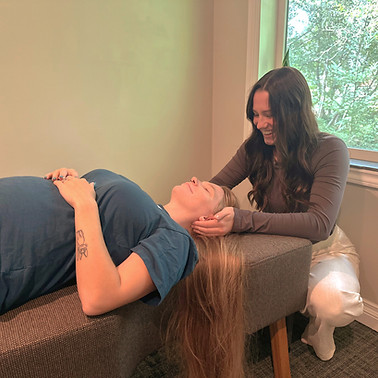 Dr. Makailee adjusts a pregnant patient