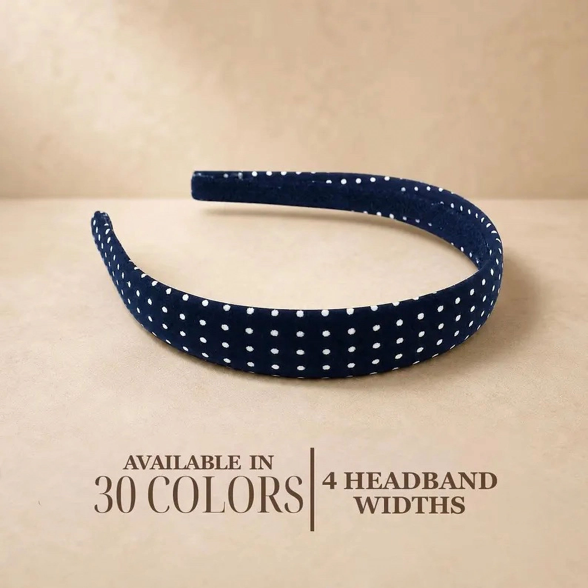 Navy polka dot 1 inch headband displayed with words "available in 30 colors and 4 headband widths"