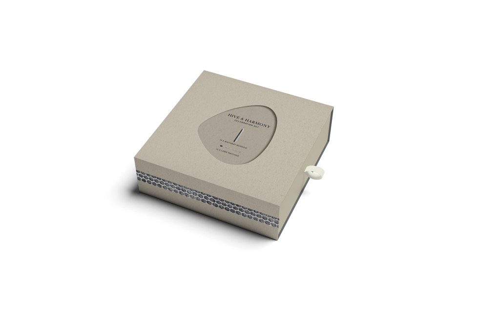 Candle packaging in slider box with die-cut showing candle contents underneath in stone colour