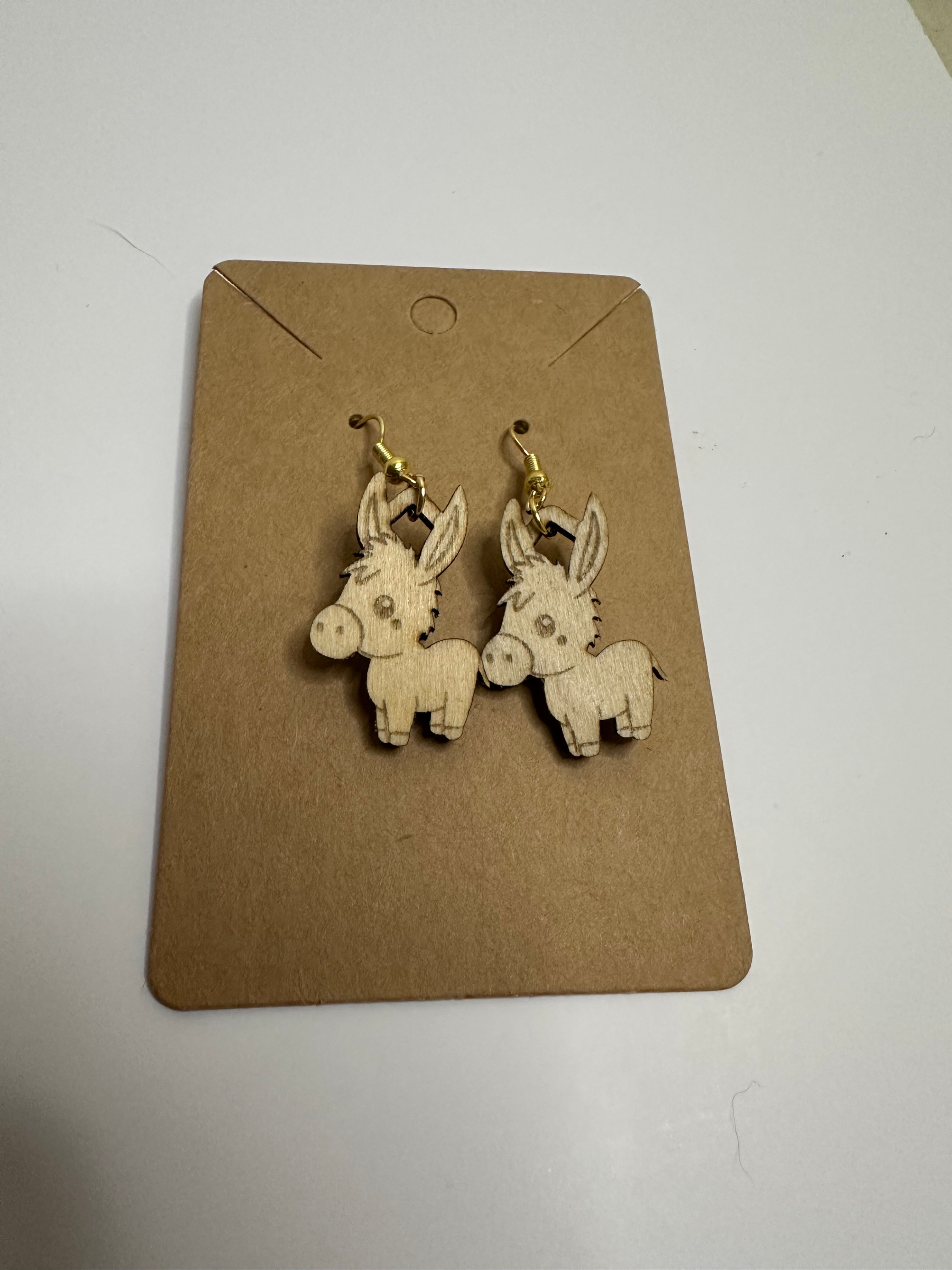 Pair of donkey earrings on a display card