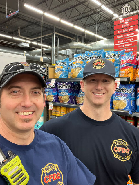 Two firefighters shopping for supplies.