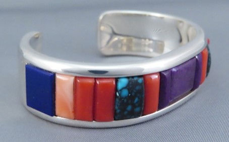 This is an example of cobblestone inlay. There are no silver channels in which to fit the stones. This means that the stones are exposed on more sides.