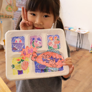 Student holding mixed media artwork at TONGWOOD Art Center in Brookline