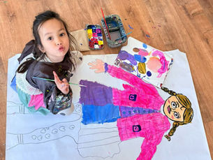 Child working on a large portrait painting at TONGWOOD Art Center