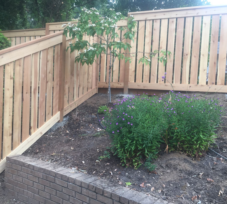 Lake Oswego outdoor living area with custom gapped cedar fencing