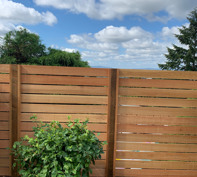 Tigard outdoor living space enclosed by horizontal cedar fencing
