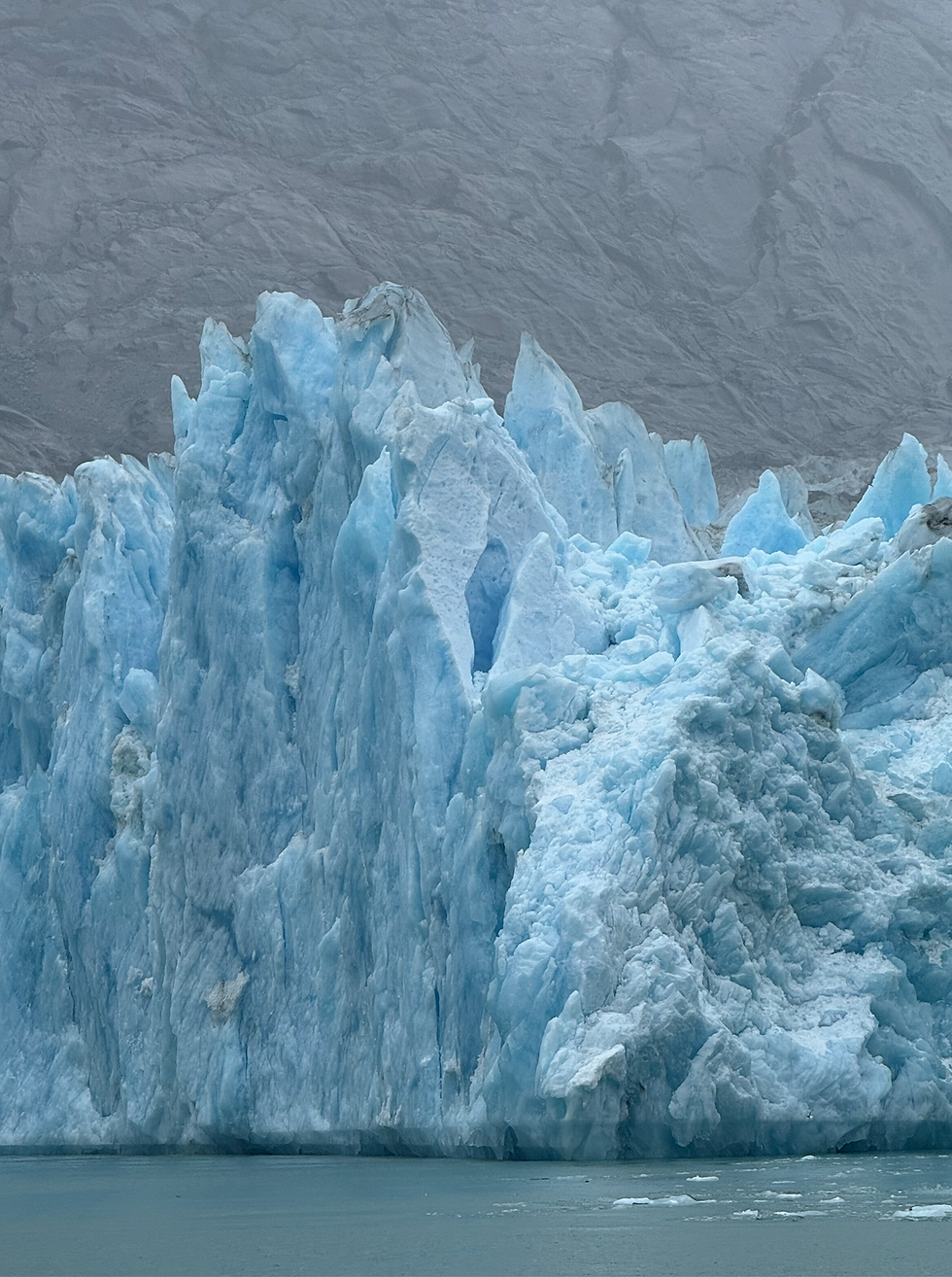 Brilliant blue ice and jagged formations at Dawes Glacier in Alaska.