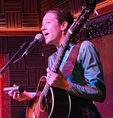Powerful singer-songwriter singing and playing guitar in Davison, NC