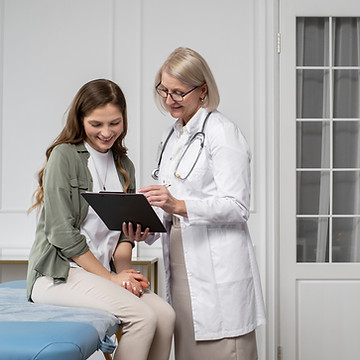medium-shot-smiley-doctor-patient-chatting.jpg
