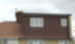 Lead flashing installed along a dormer cheek and at the base of a chimney stack