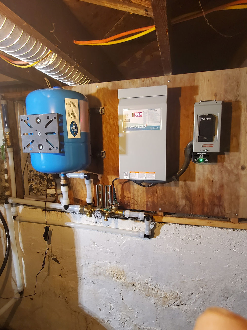 Well pump, pressure switch, and manifold piping neatly plumbed for consistent household water pressure