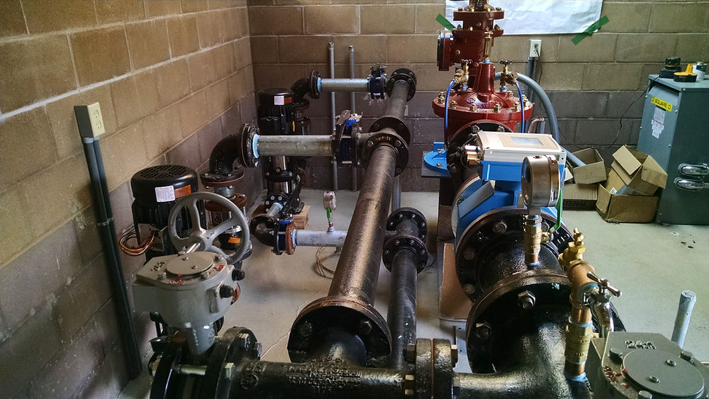 Commercial well pump control system installed in a clean, organized pump room.