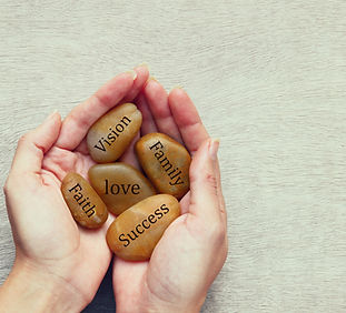 Stones of Meaning with different values on them. Value words are 'Vision', 'Family', 'Love', 'Success' and 'Faith'