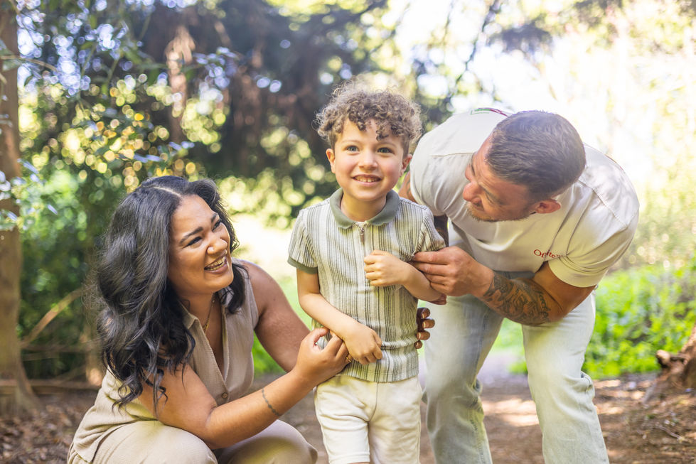Family with mum, dad and young son in Autumn colours in Delapre Abbey Northampton