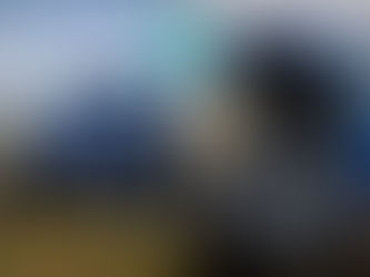 An impressive blue tractor with Tasmanian countryside background, the tractor bonnet is open showing a tiny motor.