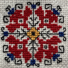 Извезан автентичен мотив на българска шевица флорален мотив с кърстат бод червени, конци бяла основа