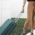 Women pulling her suitcase on wheels